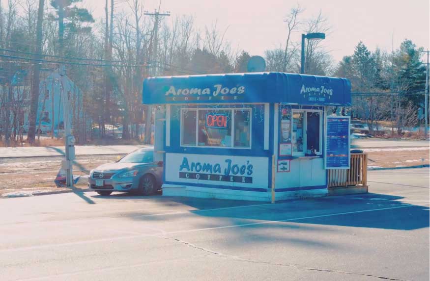 A picture of the exterior of an aroma Joe's drive-through location.