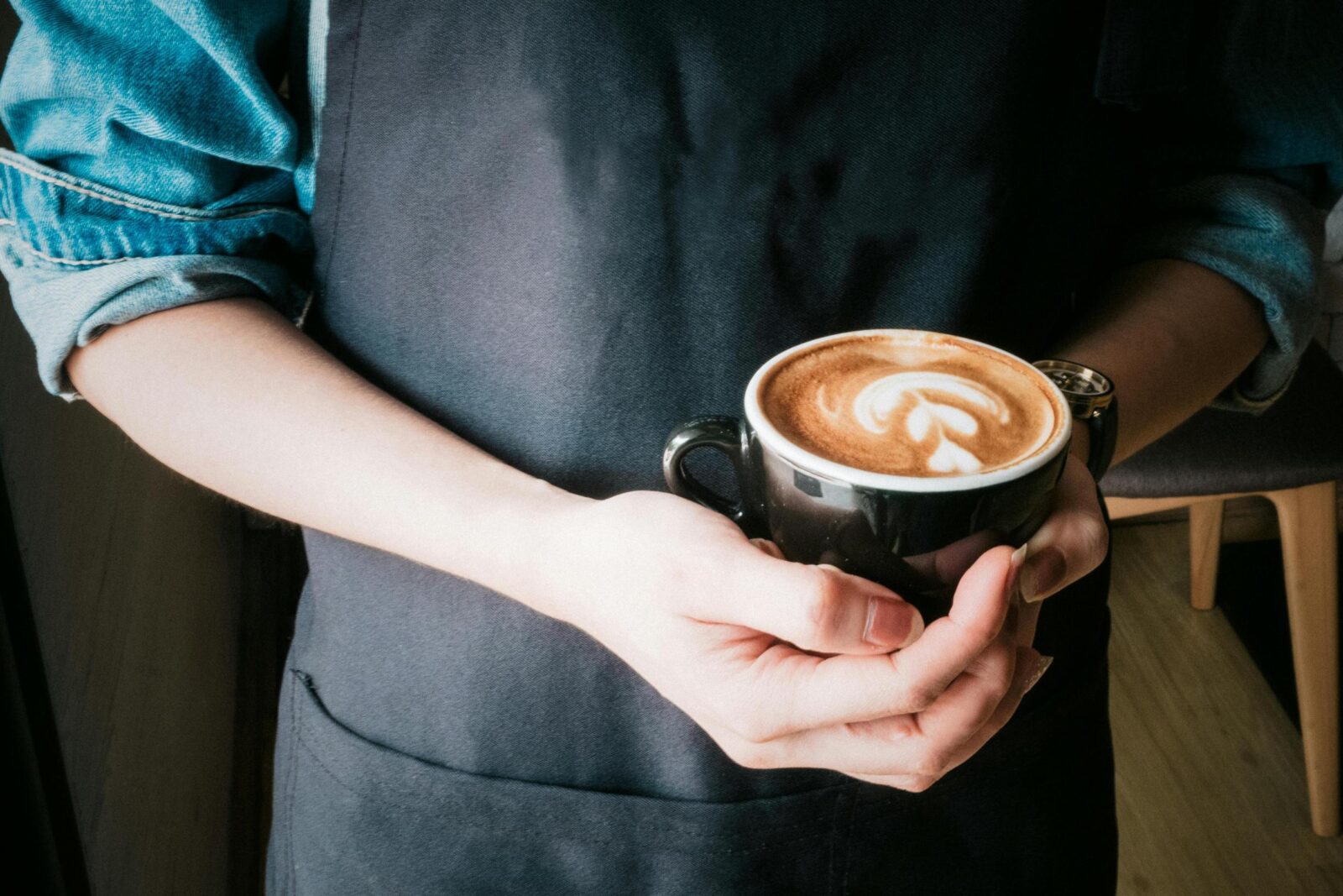 A picture of a coffee with a hand holding it. No face